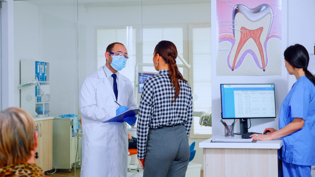 dentist doctor interrogating woman taking notes on clipboard